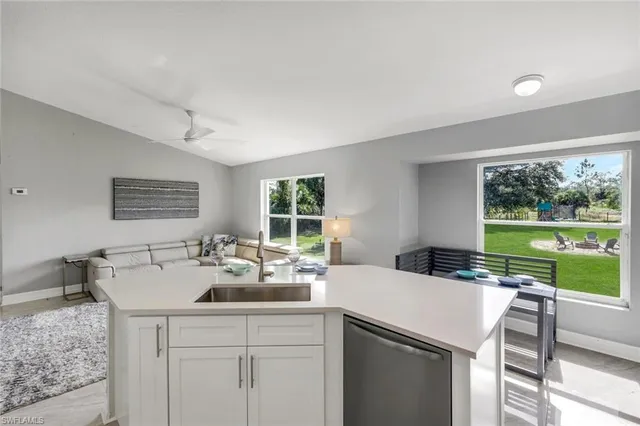 a kitchen with a sink and a large window