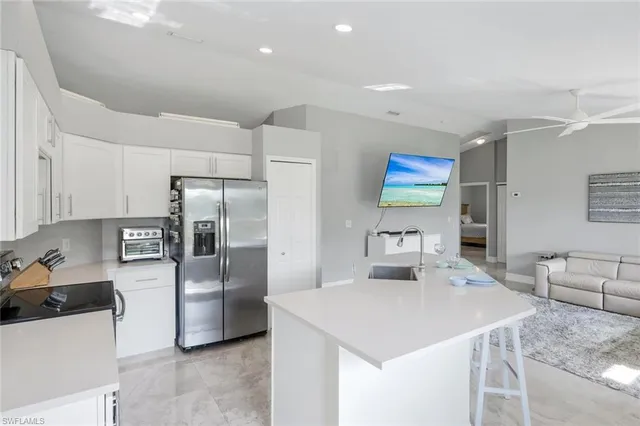 a kitchen with stainless steel appliances a refrigerator sink and stove