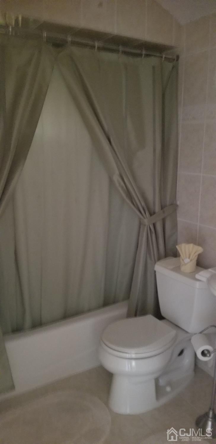 23 Spruce Street Port Reading, NJ 07064 - Photo 12 of 19 a white toilet sitting next to a shower
