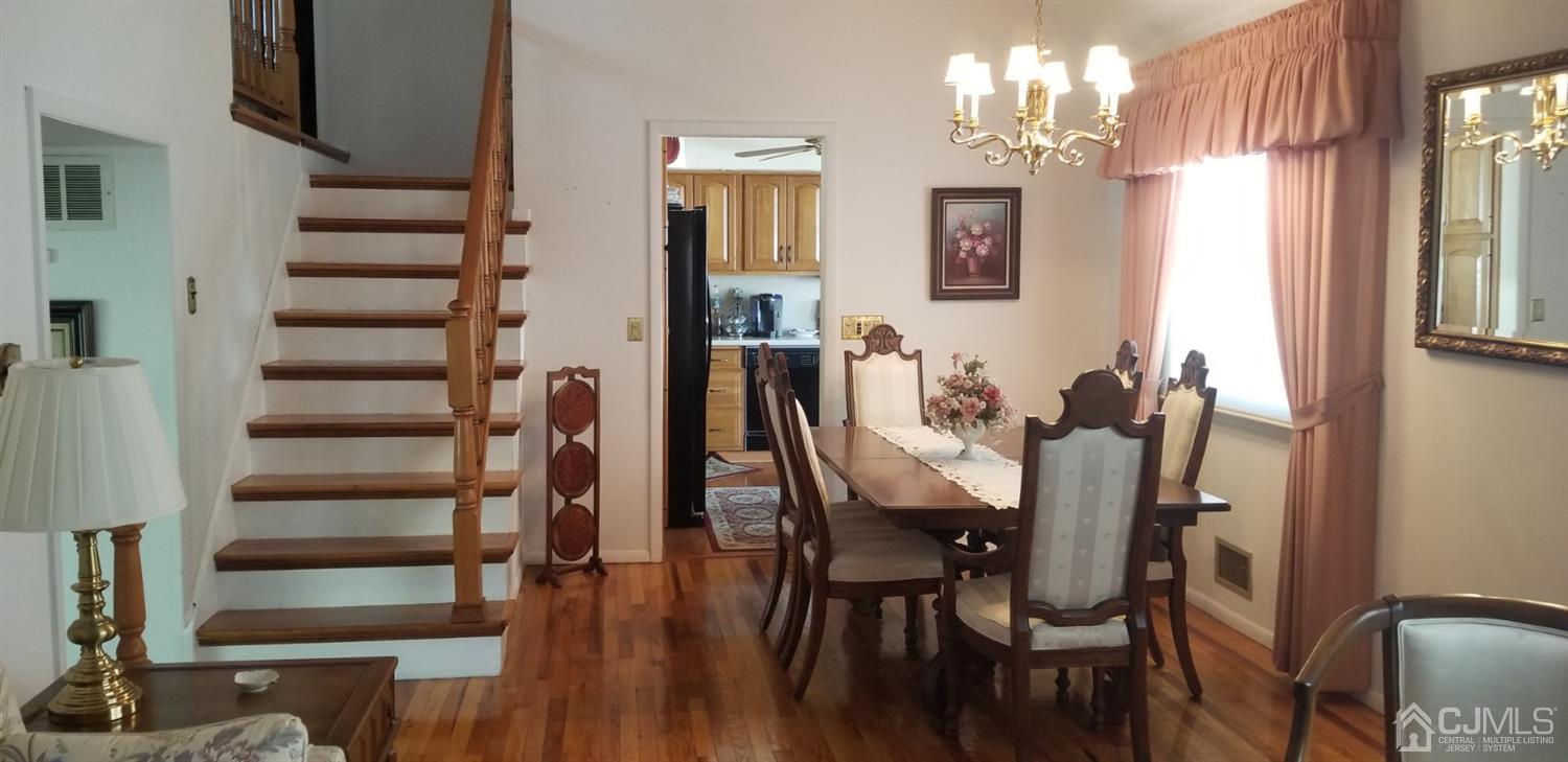 23 Spruce Street Port Reading, NJ 07064 - Photo 7 of 19 a view of a dining room with furniture and wooden floor