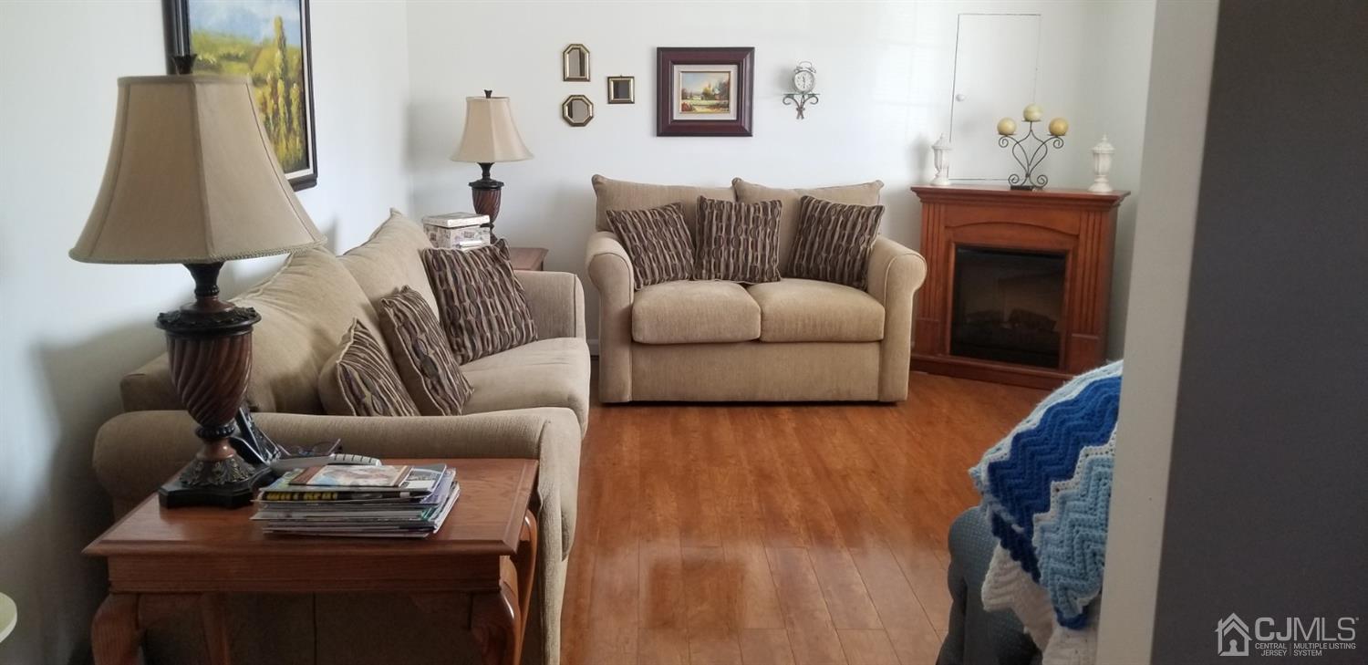 23 Spruce Street Port Reading, NJ 07064 - Photo 9 of 19 a living room with furniture and a lamp