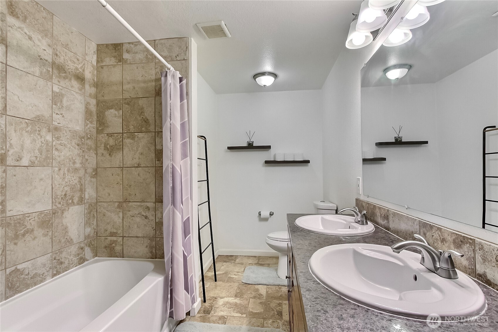 918 Gregory Way Southeast Olympia, WA 98513 - Photo 11 of 21 a bathroom with a sink a toilet a mirror a bathtub and shower