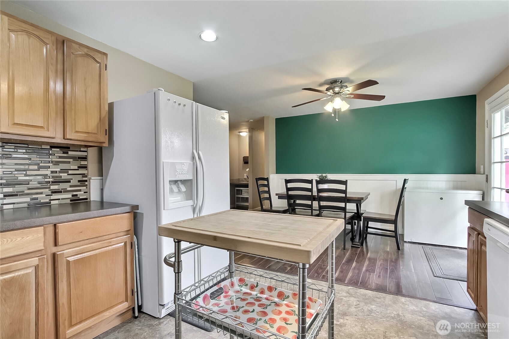 918 Gregory Way Southeast Olympia, WA 98513 - Photo 8 of 21 a kitchen with a table chairs and a refrigerator