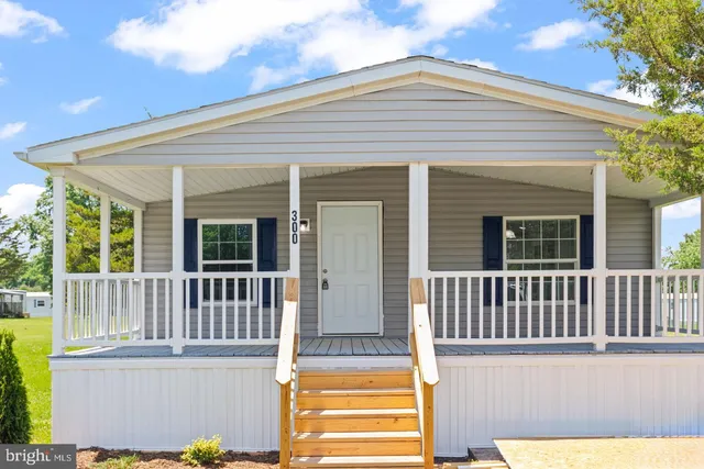a view of a house with wooden deck
