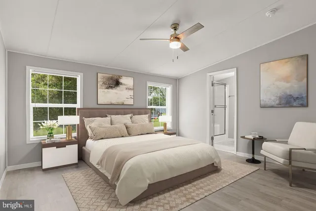 an empty room with wooden floor chandelier fan and windows