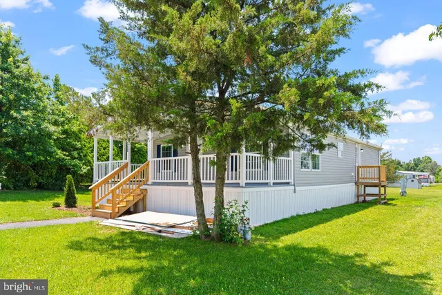 a bathroom with a tub sink vanity and mirror