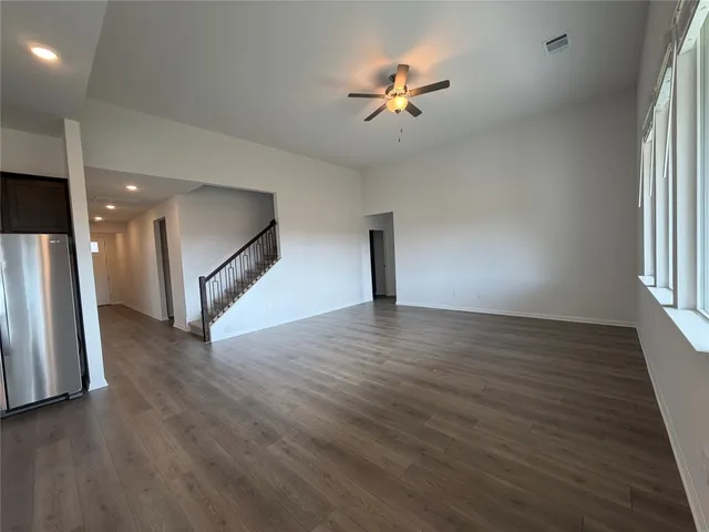 a large kitchen with stainless steel appliances a sink a stove and a refrigerator