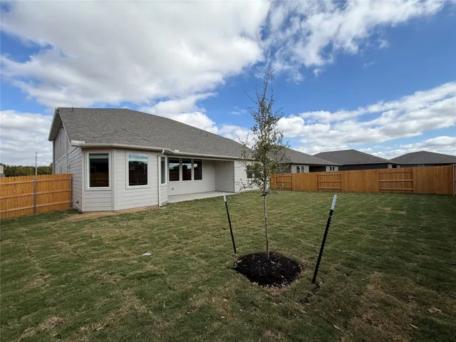 an empty room with wooden floor and natural light