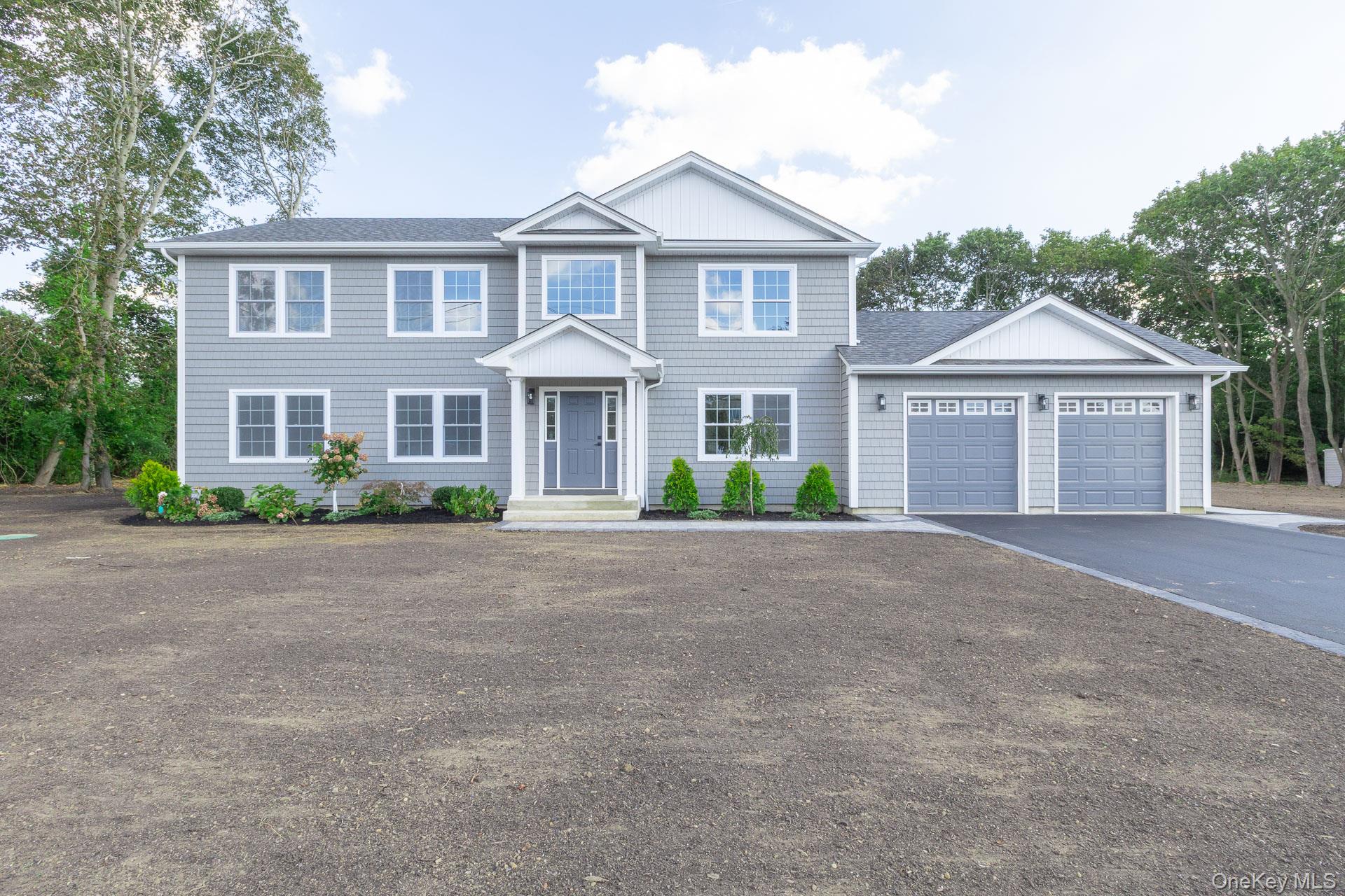 92 Park Street Blue Point, NY 11715 - Photo 3 of 32 a front view of a house with a garden