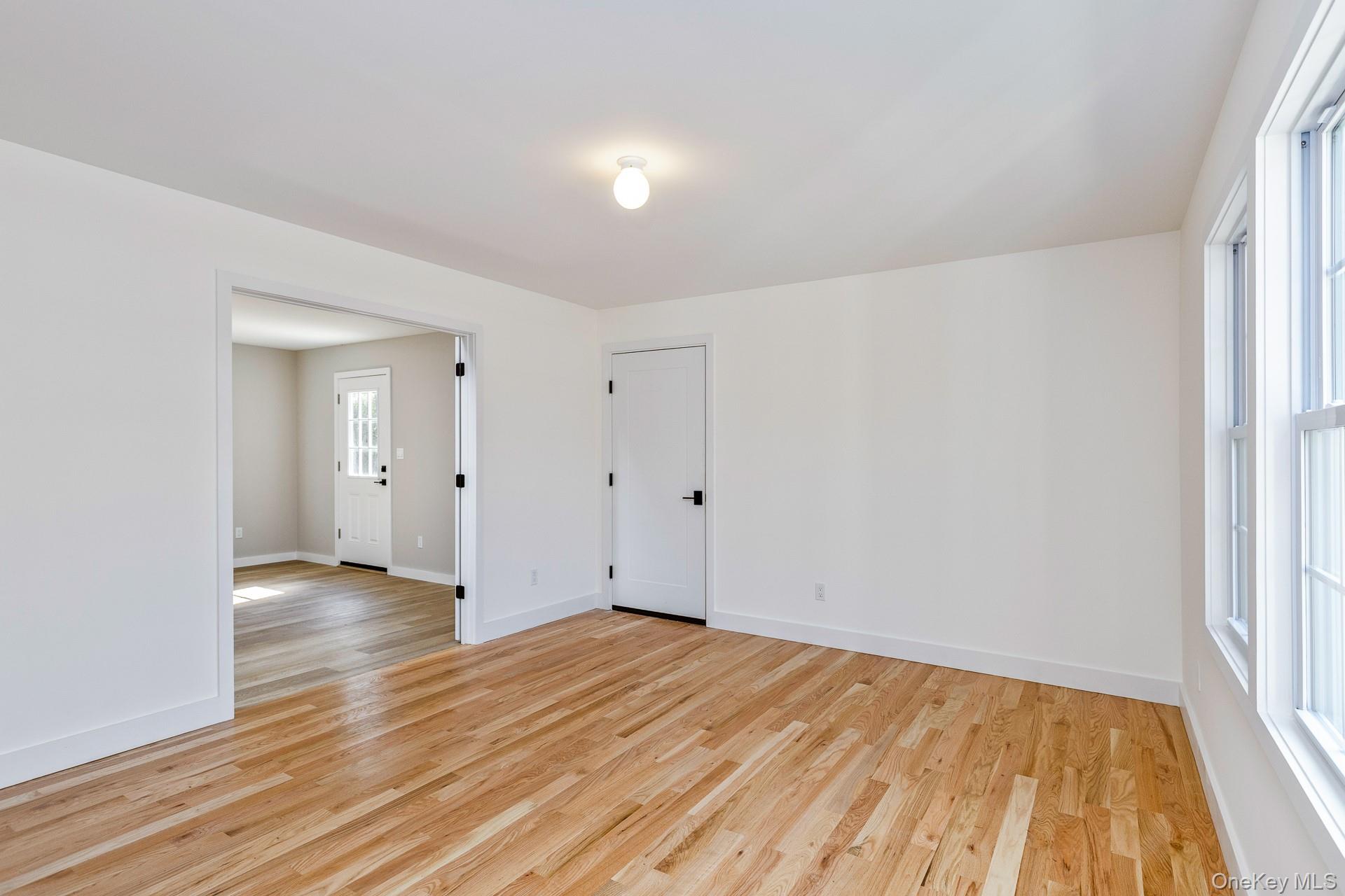 92 Park Street Blue Point, NY 11715 - Photo 9 of 32 a view of an empty room with wooden floor and a window