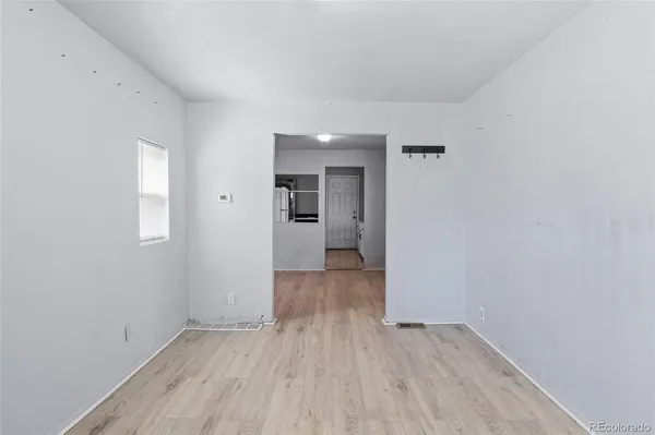 wooden floor in a hall with an empty room