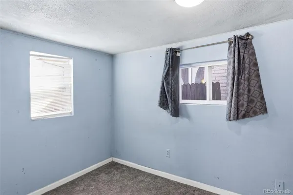 a view of a bedroom with a window and a fan