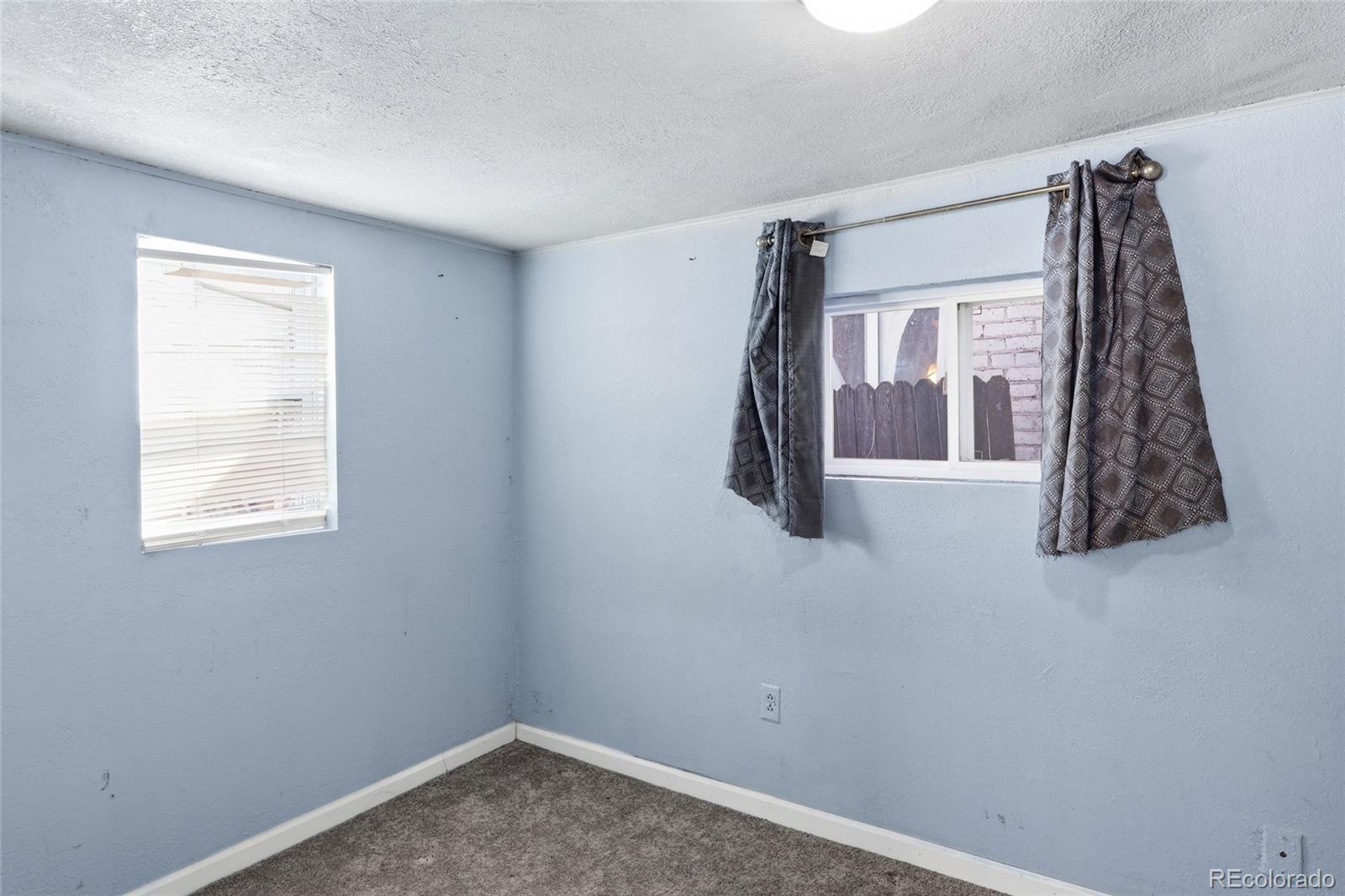 165 Hooker Street Denver, CO 80219 - Photo 6 of 11 a view of a bedroom with a window and a fan