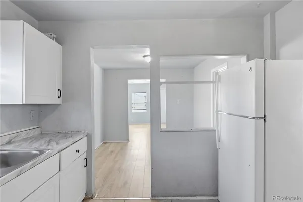a kitchen with a refrigerator and a sink