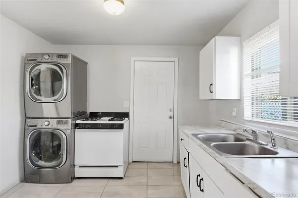 a utility room with sink dryer and washer
