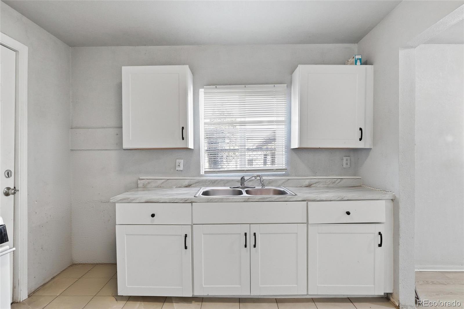 165 Hooker Street Denver, CO 80219 - Photo 9 of 11 a sink with white cabinets