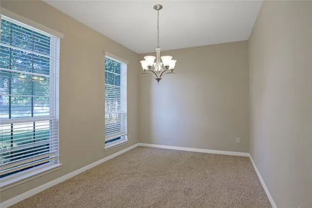 a view of a room with windows and chandelier