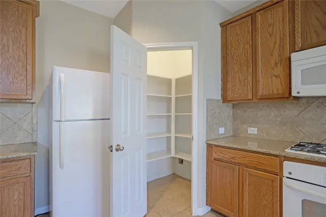 a kitchen with a refrigerator and cabinets