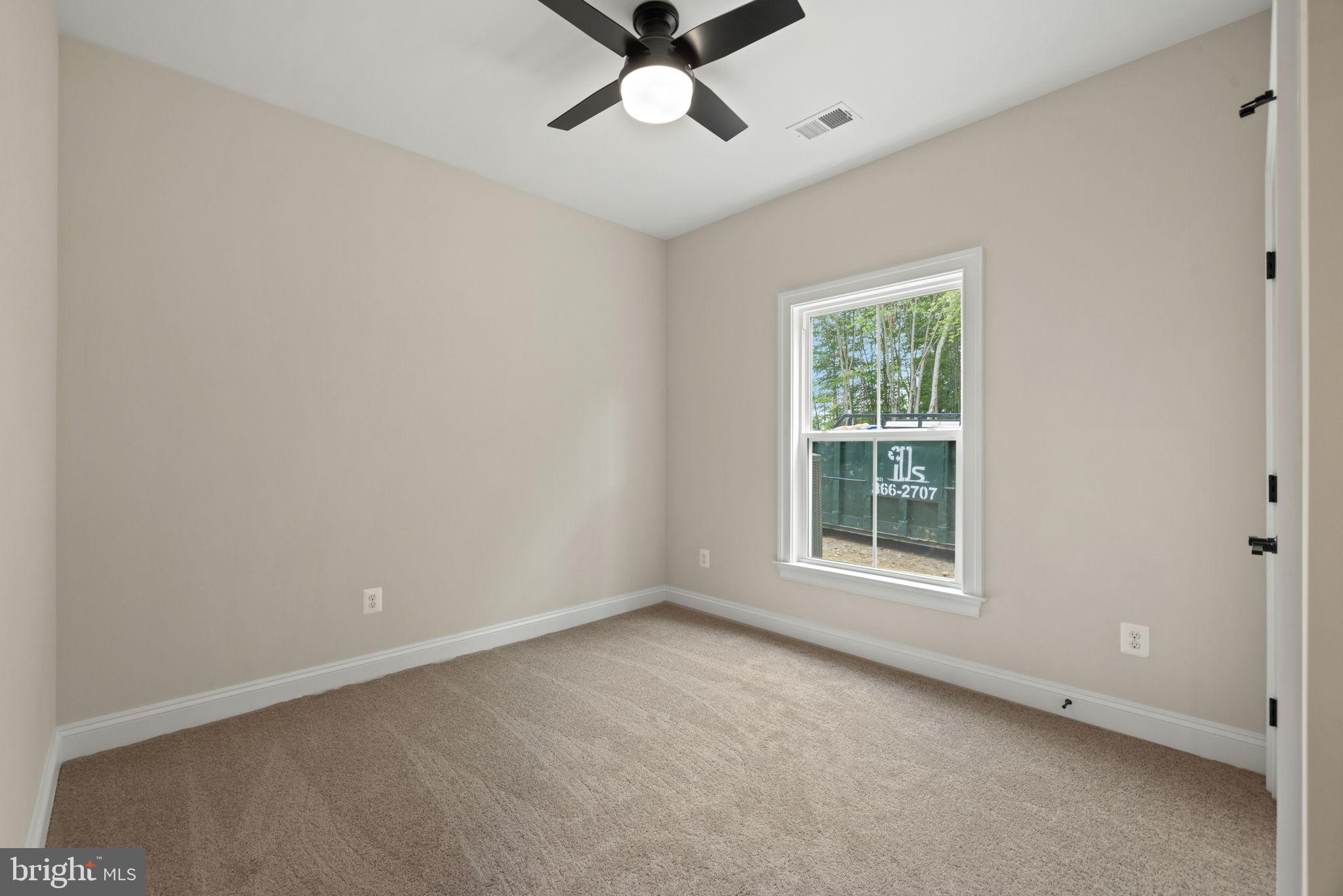 7329 Riley Road Warrenton, VA 20187 - Photo 22 of 69 an empty room with a window and a fan