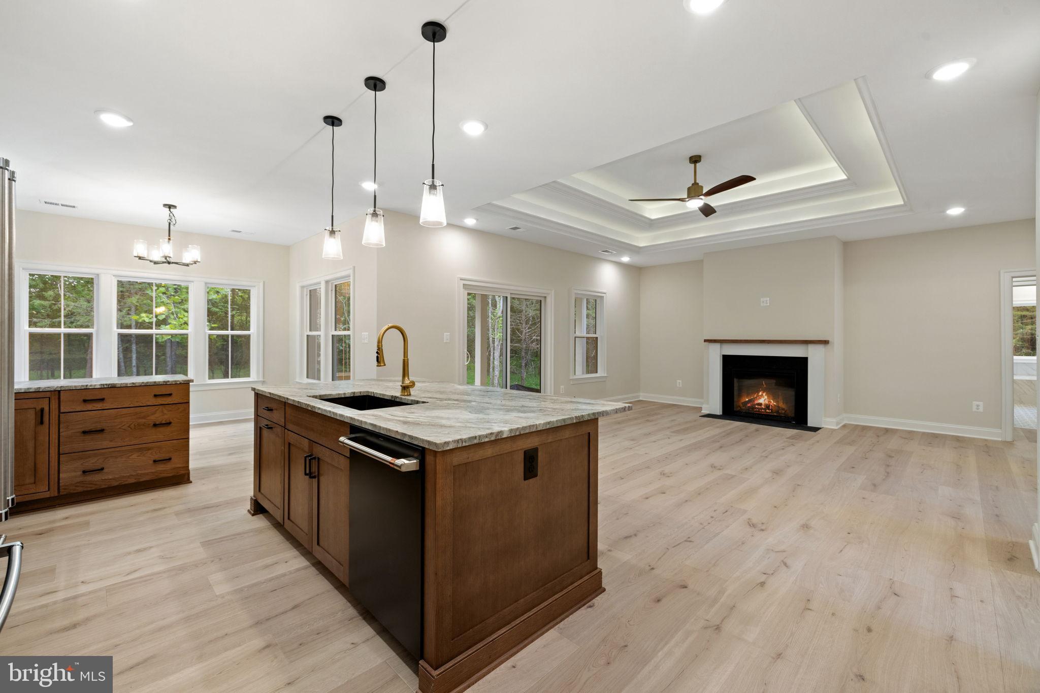 7329 Riley Road Warrenton, VA 20187 - Photo 29 of 69 a kitchen with kitchen island a stove a sink and a wooden floors