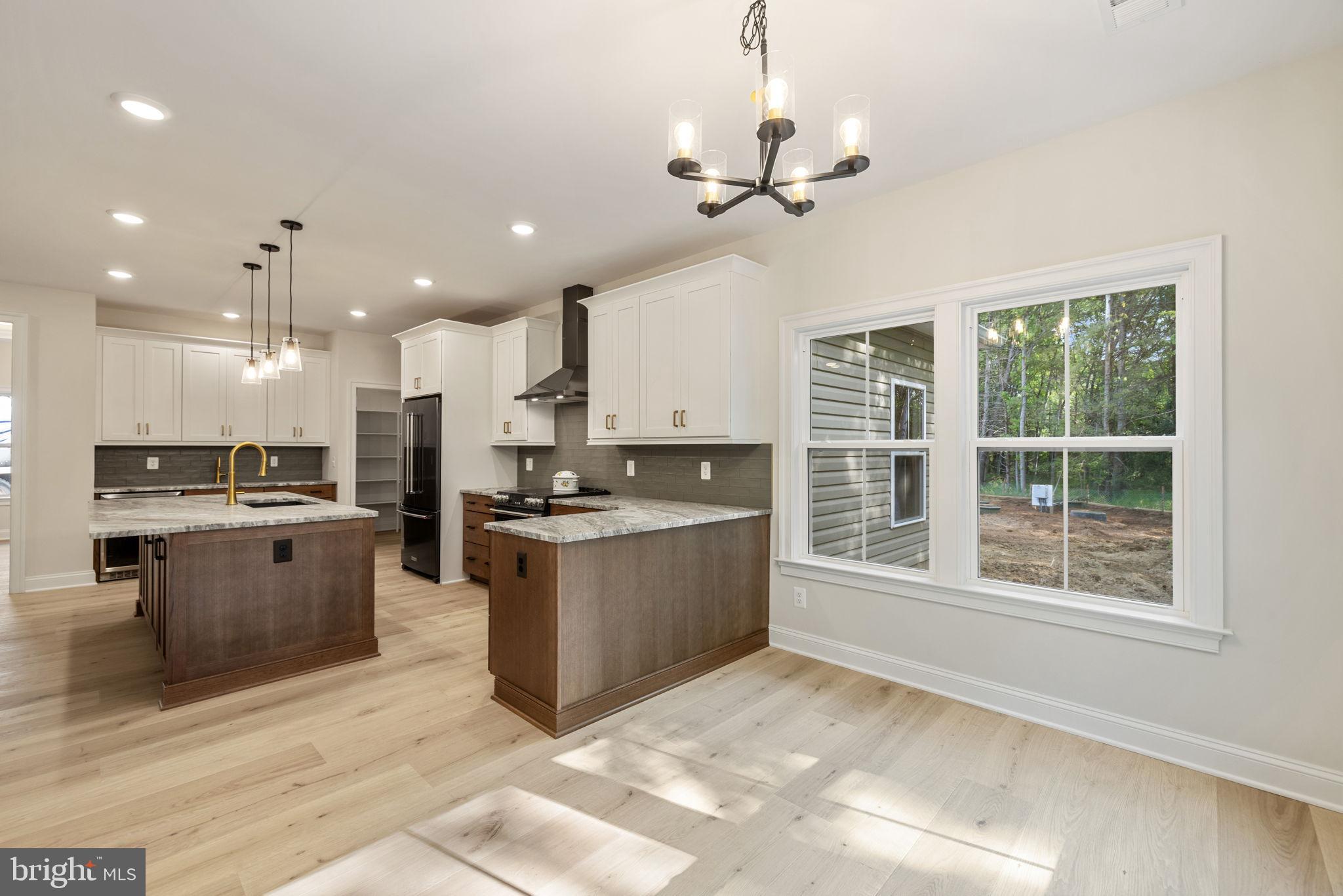 7329 Riley Road Warrenton, VA 20187 - Photo 39 of 69 a large kitchen with kitchen island a large counter top space appliances and cabinets