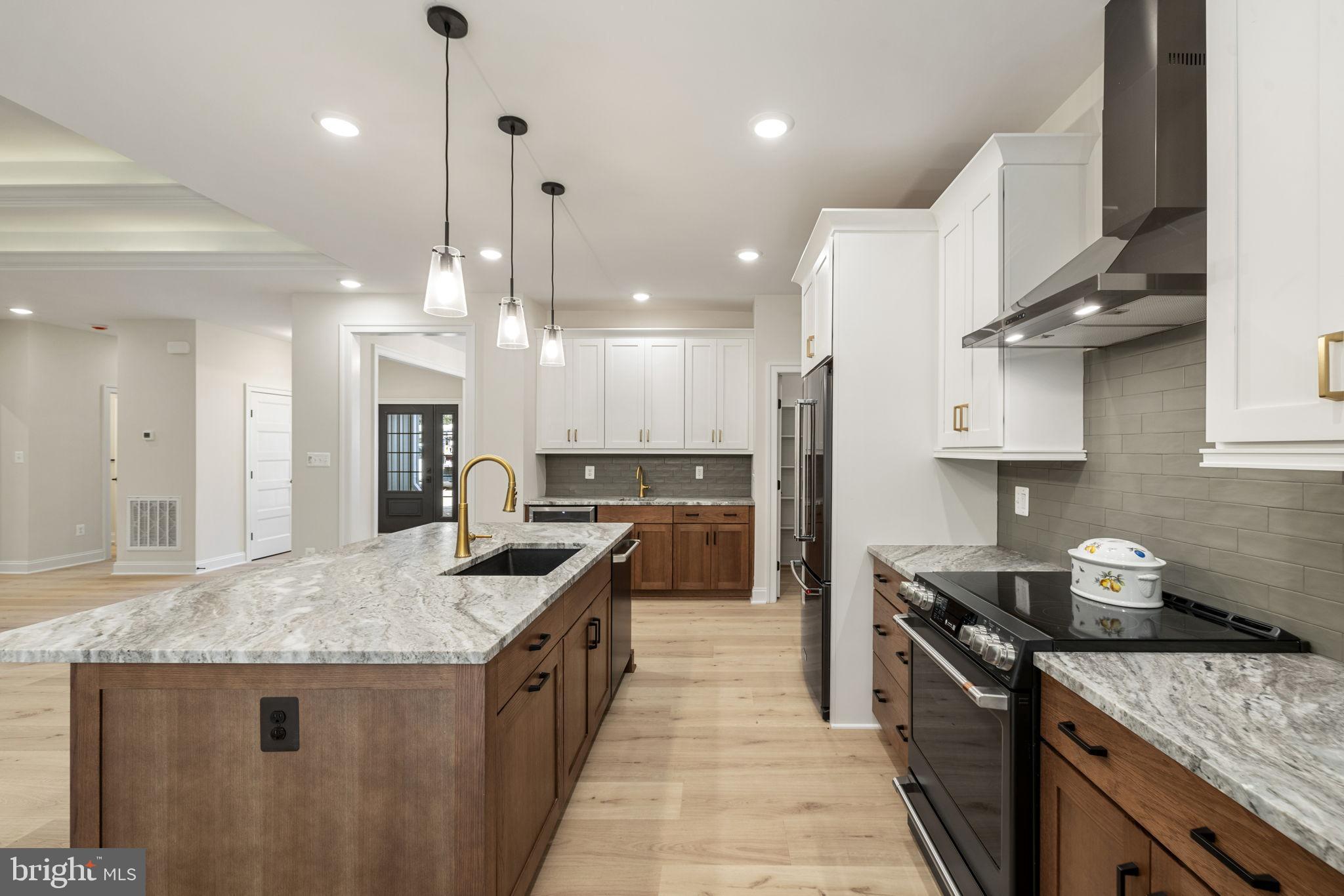 7329 Riley Road Warrenton, VA 20187 - Photo 41 of 69 a kitchen with stainless steel appliances granite countertop a sink a stove and a wooden floors
