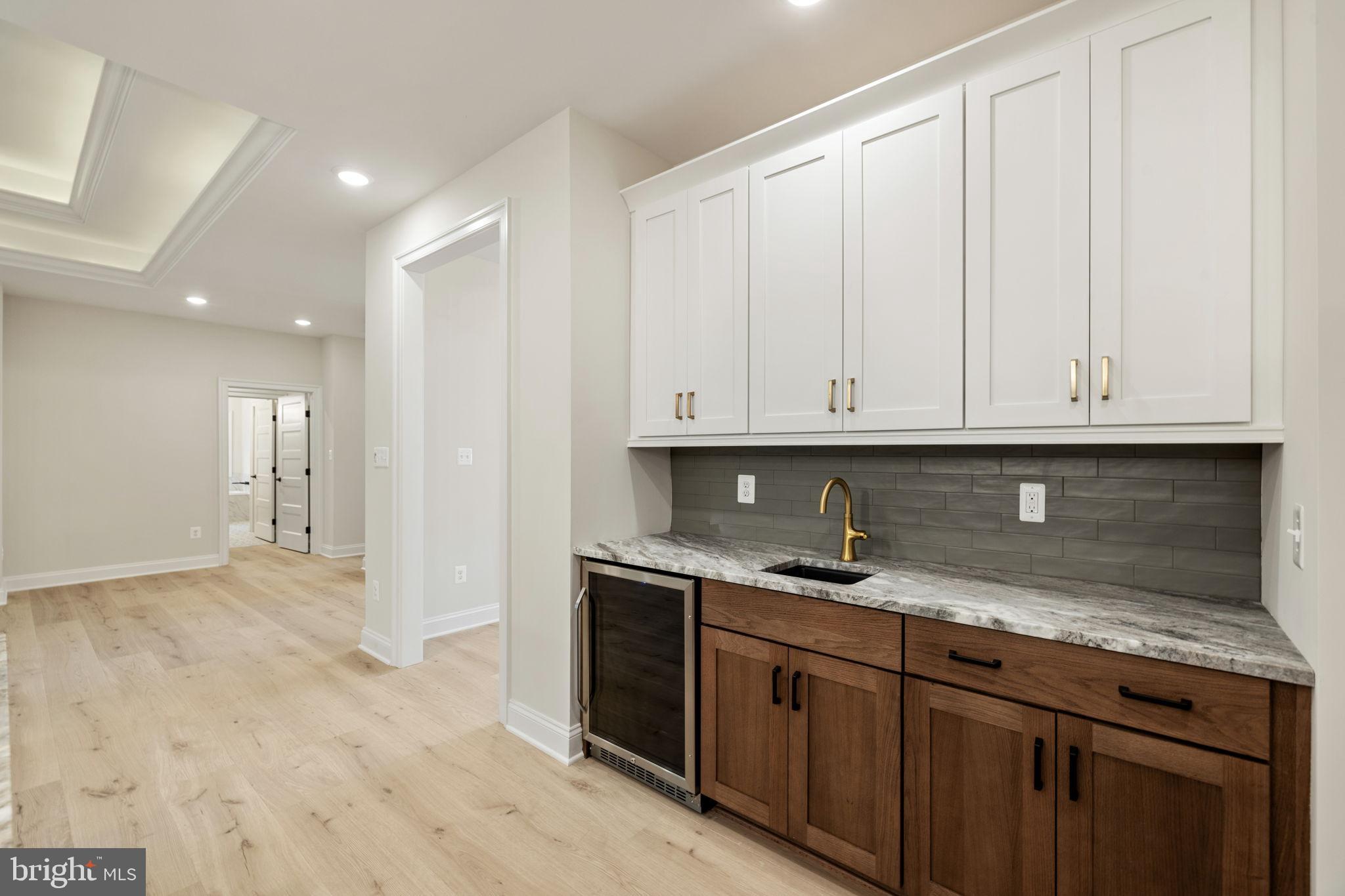 7329 Riley Road Warrenton, VA 20187 - Photo 44 of 69 a kitchen with granite countertop white cabinets and sink
