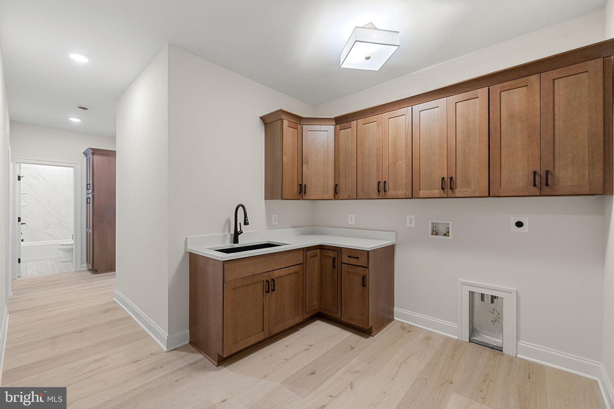 7329 Riley Road Warrenton, VA 20187 - Photo 47 of 69 a kitchen with a sink cabinets and wooden floor