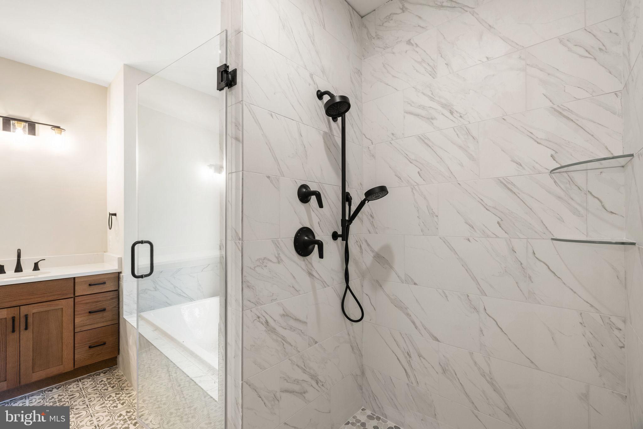 7329 Riley Road Warrenton, VA 20187 - Photo 61 of 69 a bathroom with a granite countertop shower a sink and a shower