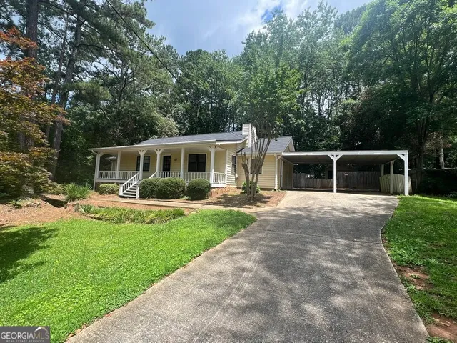 a front view of house with yard and green space