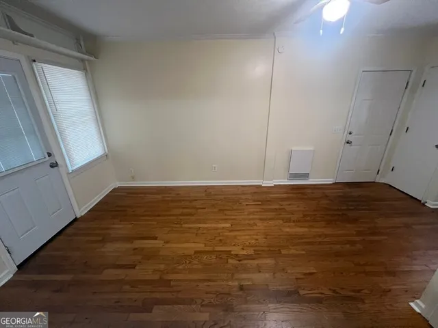 a view of room with window and hardwood floor