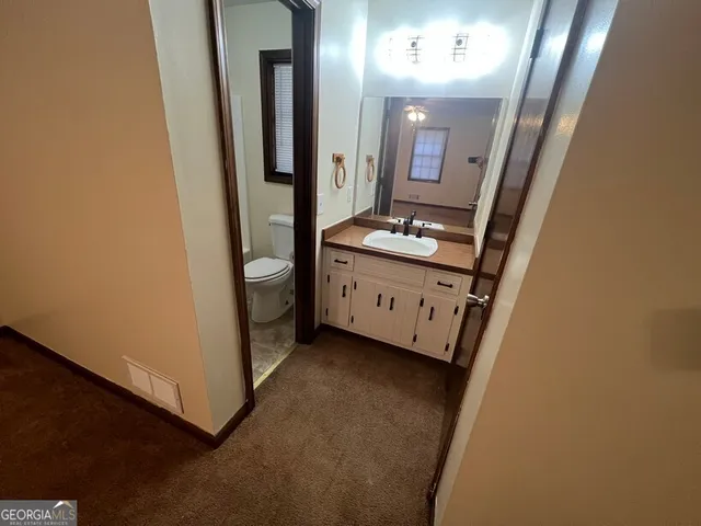 a bathroom with a sink a mirror and a toilet