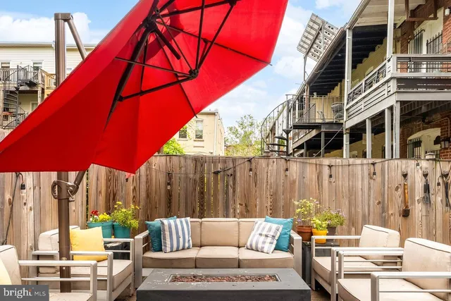 a backyard of a house with barbeque oven table and chairs