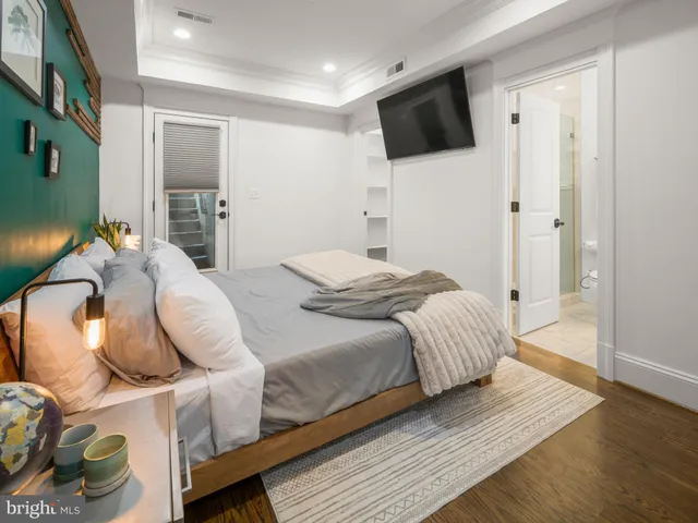 a bedroom with a bed and flat screen tv