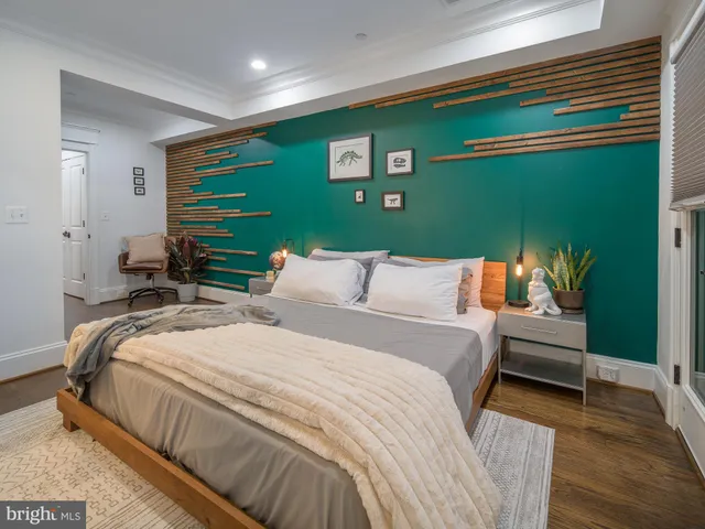 a bedroom with a bed and a large window