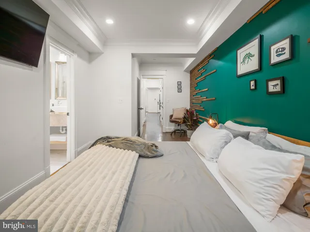 a bed room with a bed and a television