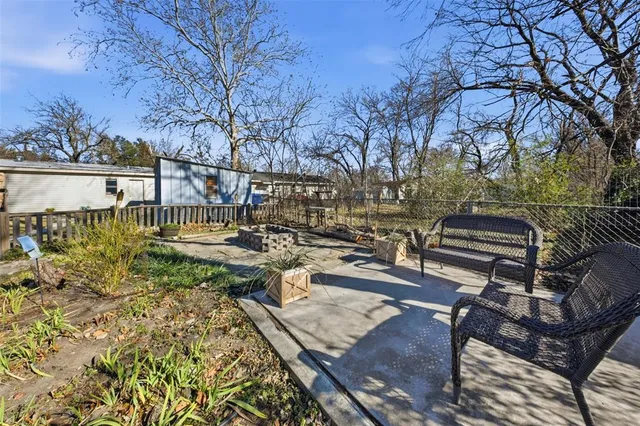 a view of a backyard with sitting area