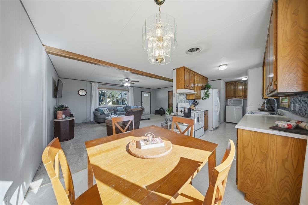 610 Walter Road Gainesville, TX 76240 - Photo 4 of 33 a view of a dining room with furniture and a chandelier