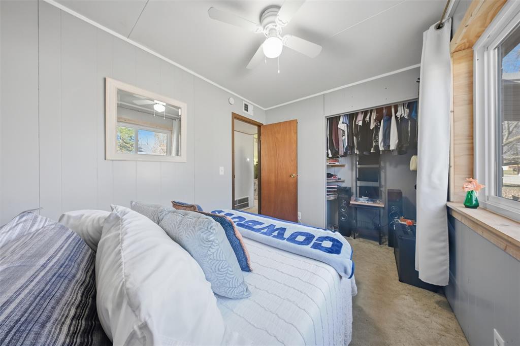 610 Walter Road Gainesville, TX 76240 - Photo 6 of 33 a bedroom with a bed and a chandelier