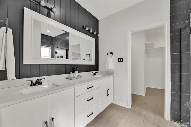 a room with walk in closet with empty racks