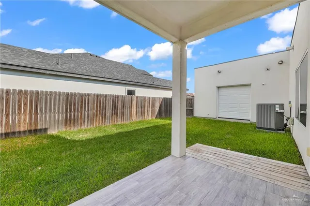a view of a backyard with plants and a big yard