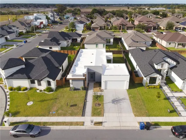 an aerial view of residential houses with outdoor space
