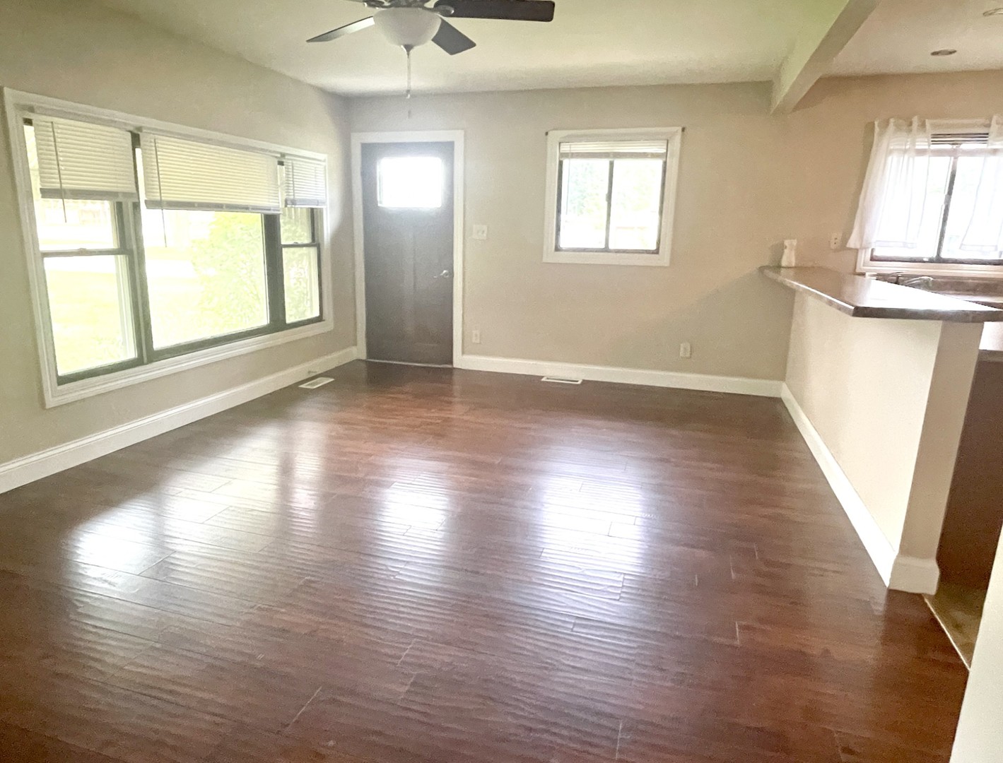 1415 Plain Street Peru, IL 61354 - Photo 2 of 17 an empty room with wooden floor and windows