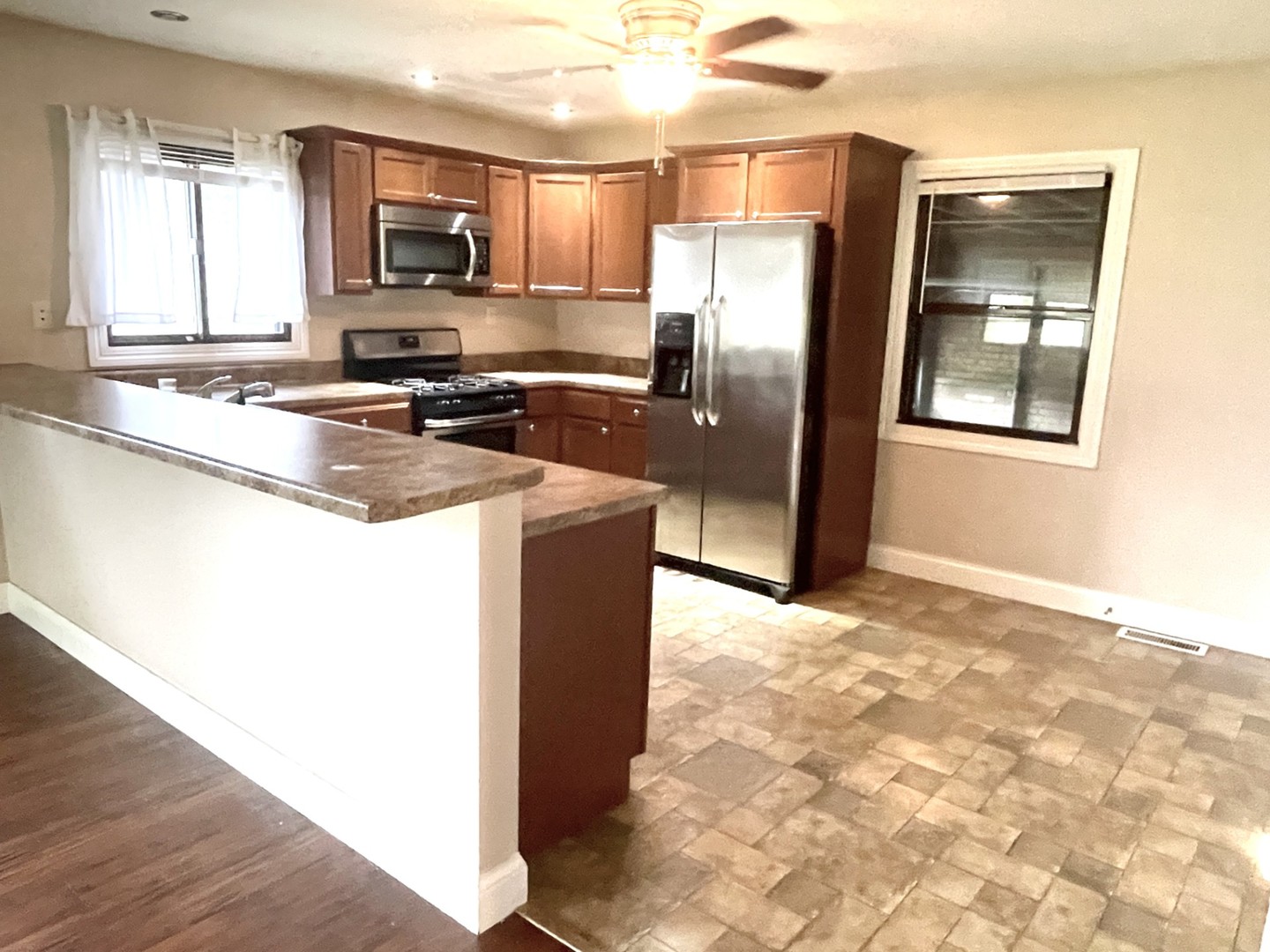 1415 Plain Street Peru, IL 61354 - Photo 4 of 17 a kitchen with stainless steel appliances granite countertop a refrigerator a stove a sink and a microwave