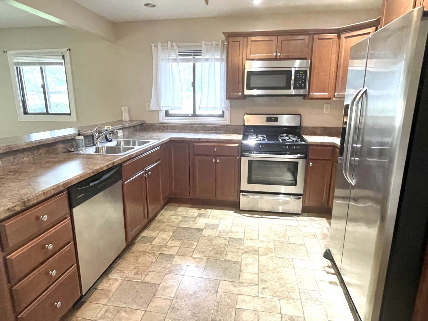 1415 Plain Street Peru, IL 61354 - Photo 5 of 17 a kitchen with stainless steel appliances granite countertop a sink stove and microwave