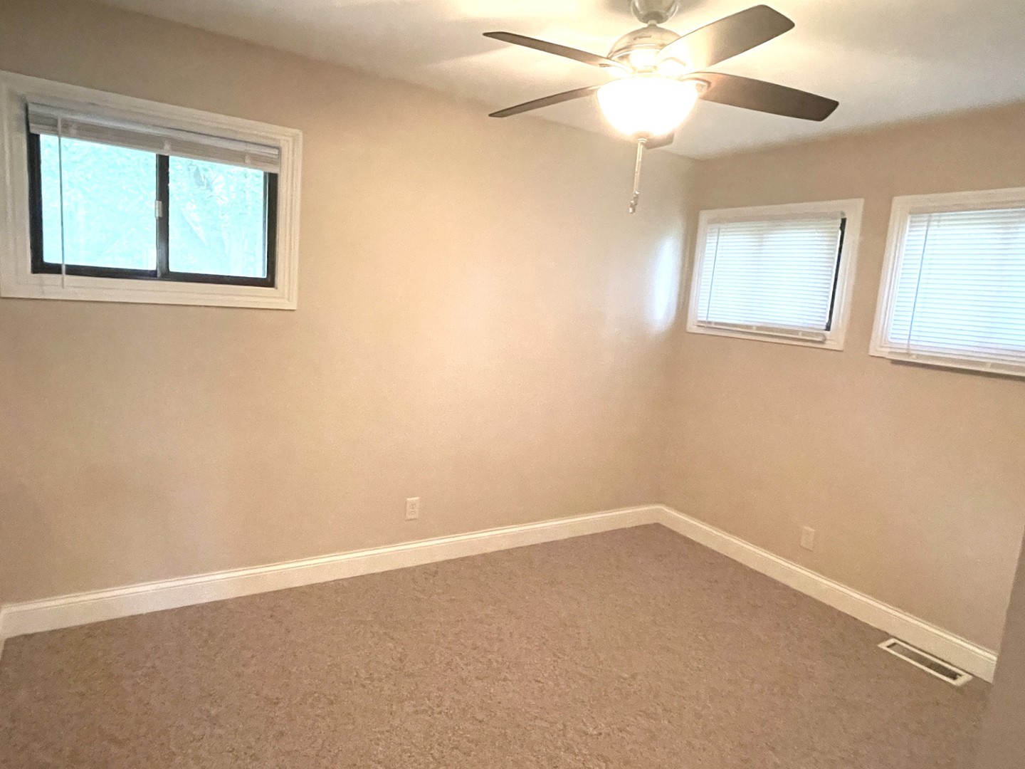1415 Plain Street Peru, IL 61354 - Photo 7 of 17 an empty room with a window and a fan