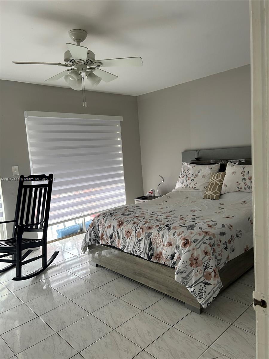 West End Miami, FL 33193 - Photo 13 of 19 a bedroom with a bed and chair