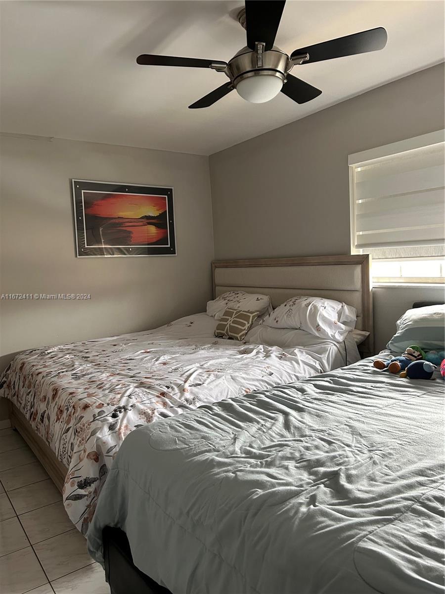 West End Miami, FL 33193 - Photo 17 of 19 a bedroom with bed and a painting on the wall