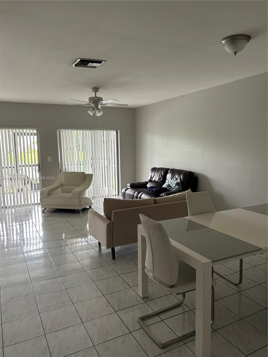 West End Miami, FL 33193 - Photo 3 of 19 a living room with furniture and a chandelier