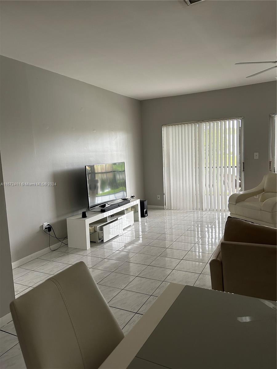 West End Miami, FL 33193 - Photo 4 of 19 a living room with furniture and a flat screen tv